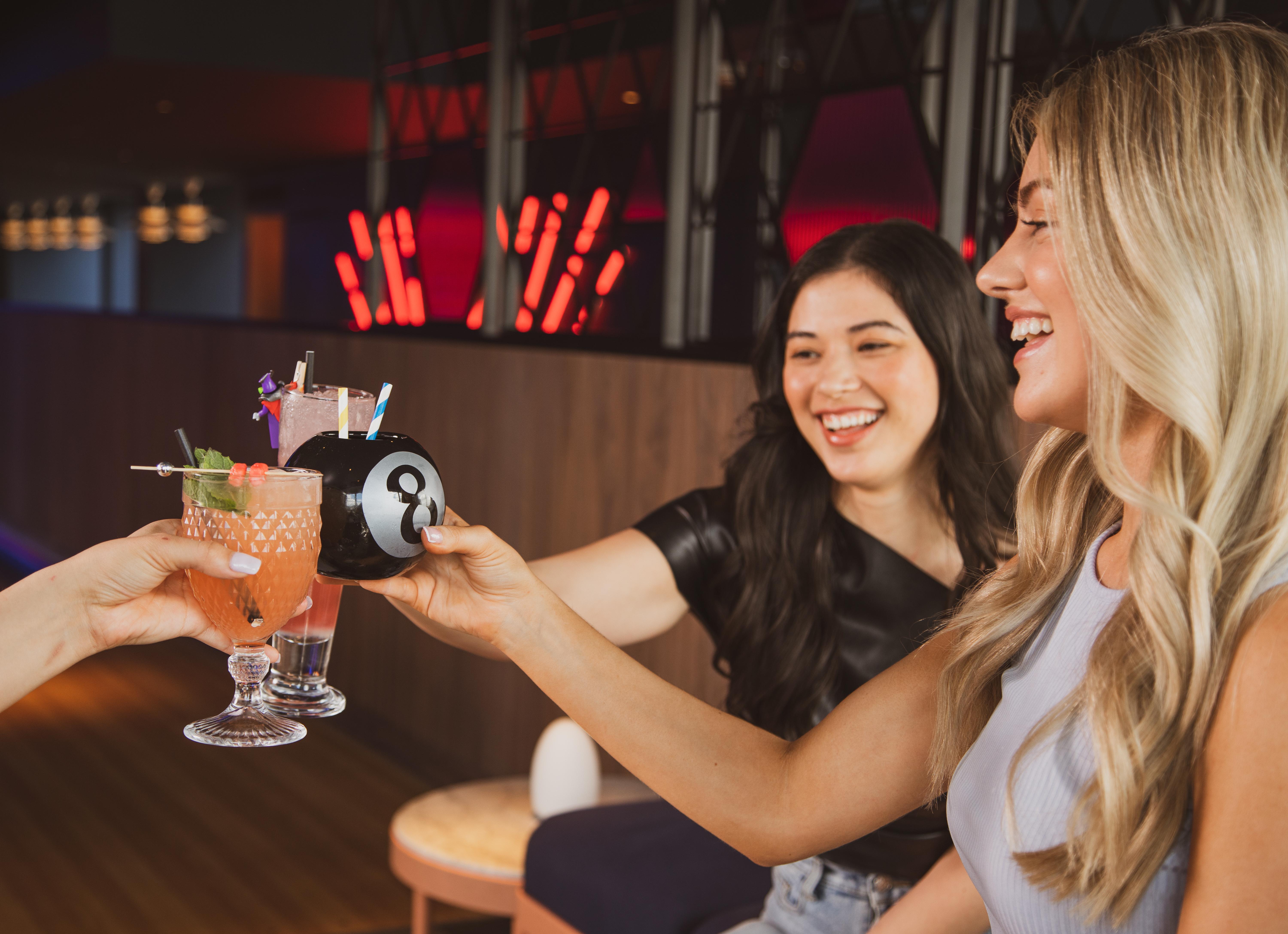 Yotel Glasgow Dış mekan fotoğraf Two women toasting with drinks.